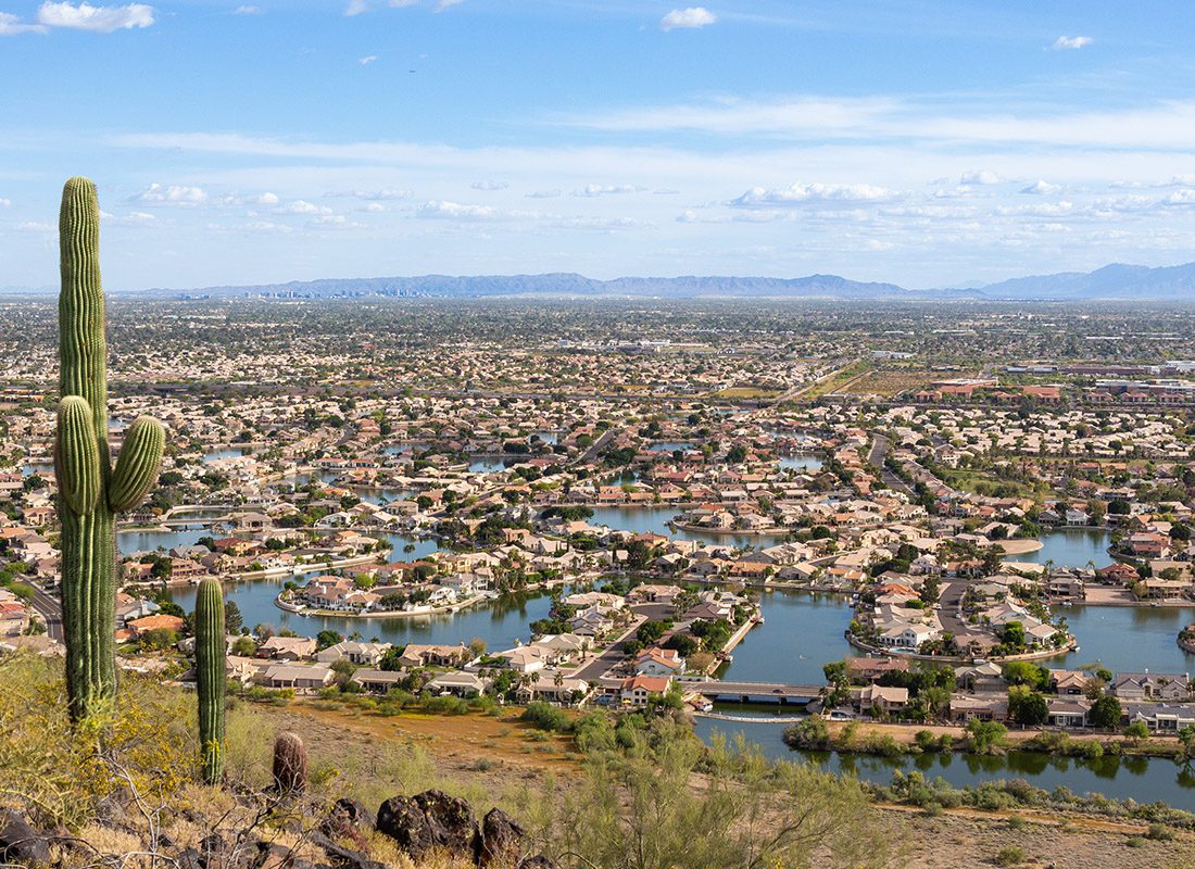 Glendale AZ - Aerial View of Glendale AZ Overlooking Bodies of Water With a Cactus in the Foreground on a Sunny Day