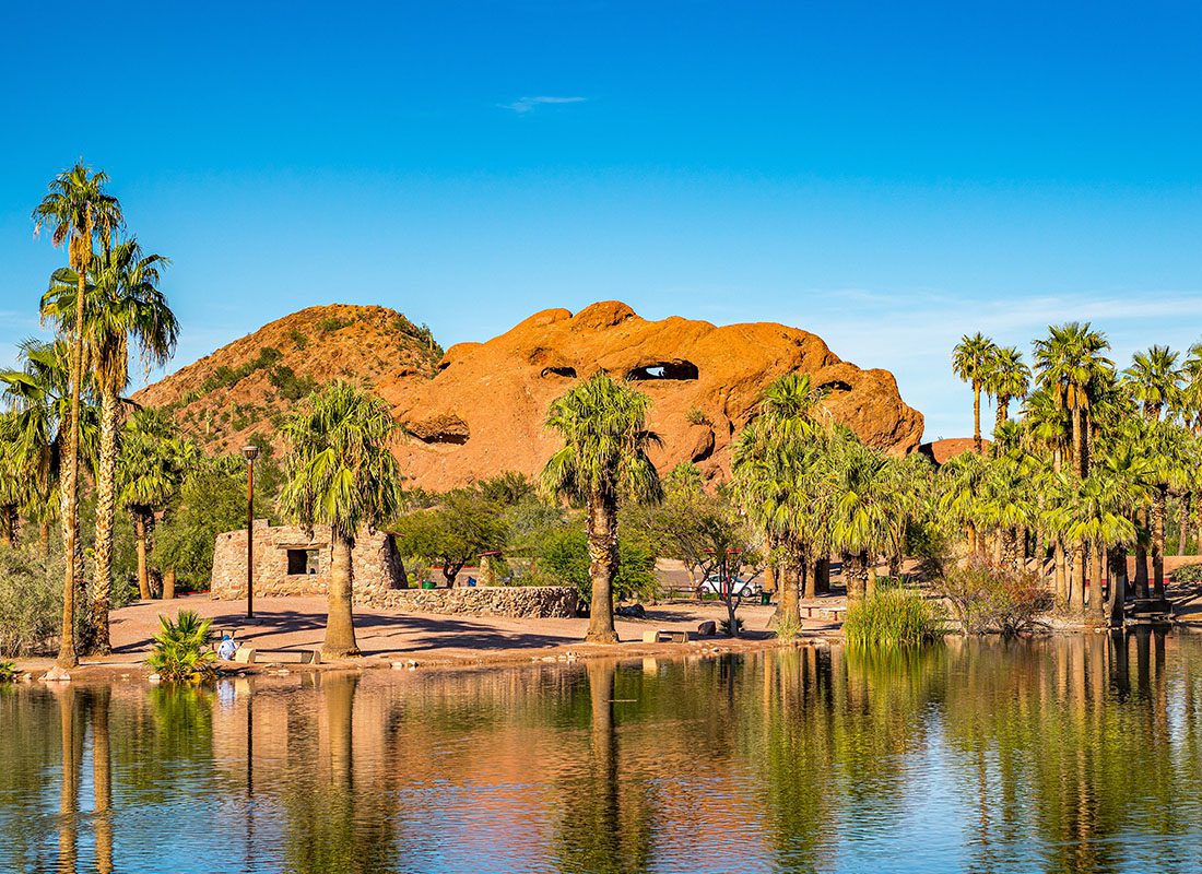 Phoenix, AZ - Aerial View of Papago Park in Phoenix, Arizona With Palm Trees and a Lake on a Sunny Day